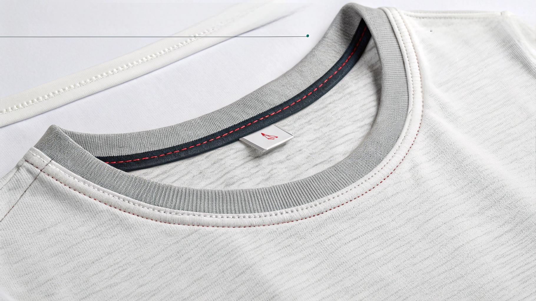 Close-up comparison of premium T-shirt construction details featuring double-needle stitching on hems, taped shoulder seams, and reinforced collars with Lycra ribbing, along with fabric tags indicating 180–220 GSM weight, soft structured cotton texture, clean seam finishes, and no loose threads, set against a textile studio or tailor workshop background for an educational and high-end product showcase
